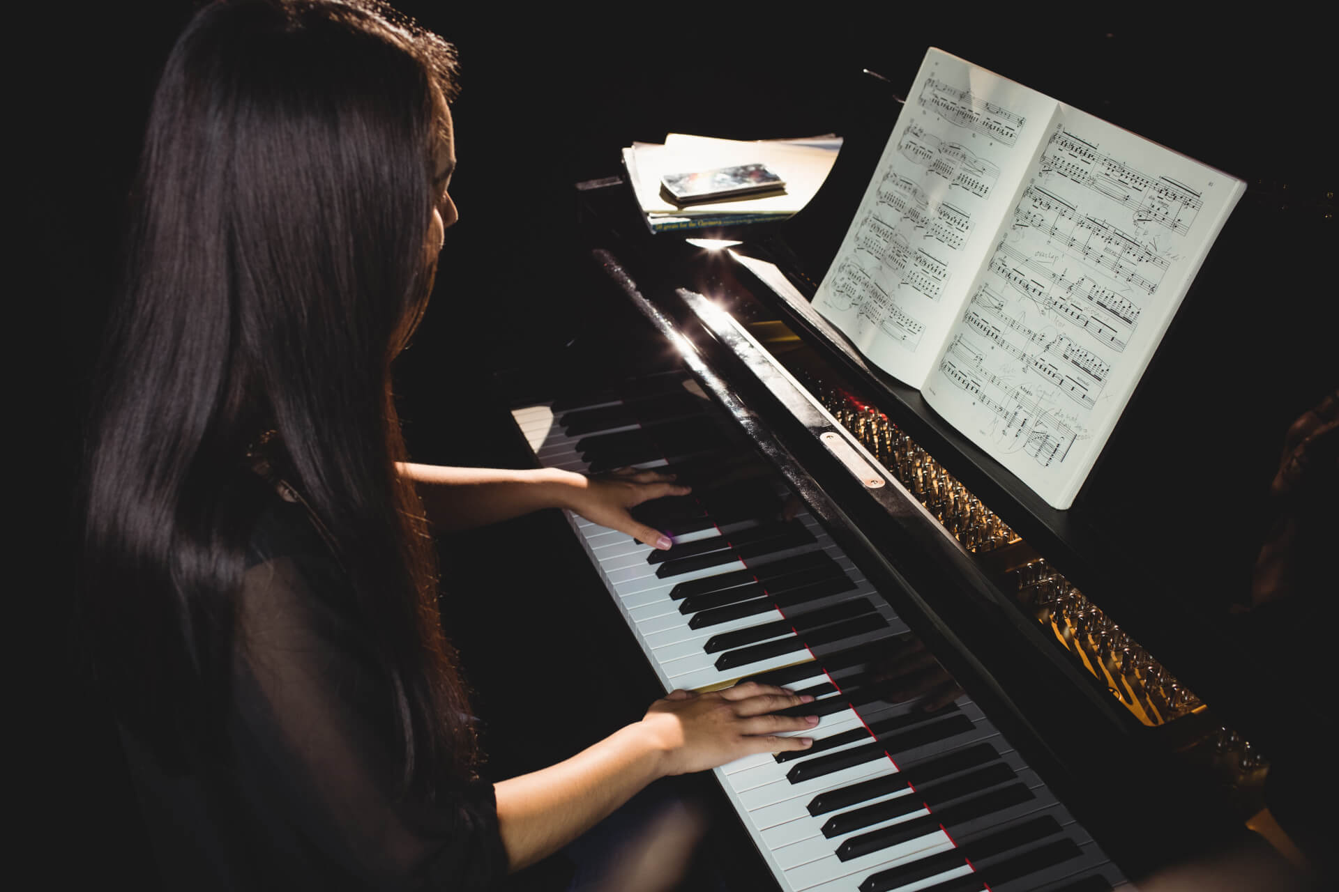 female musician playing the piano making music